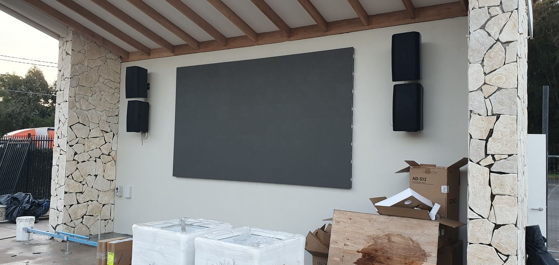 The outdoor courtyard LED screen and its flanking speakers built into the covered stage area.